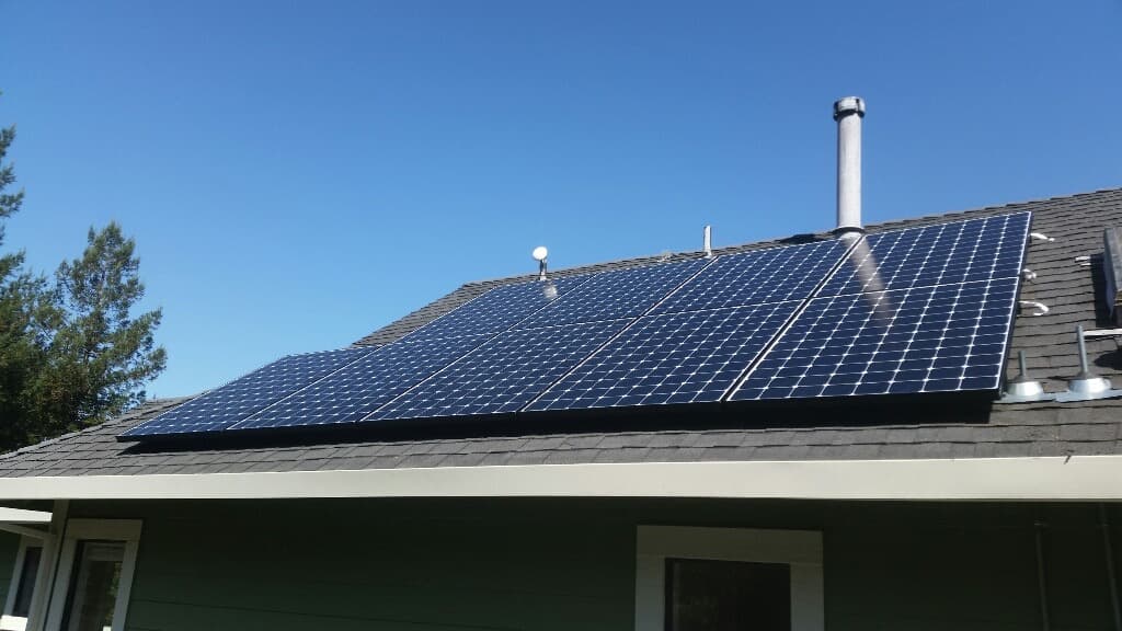 Solar Panels on Green Residential Roof During Day